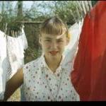 Teenager hanging clothes on clothesline
